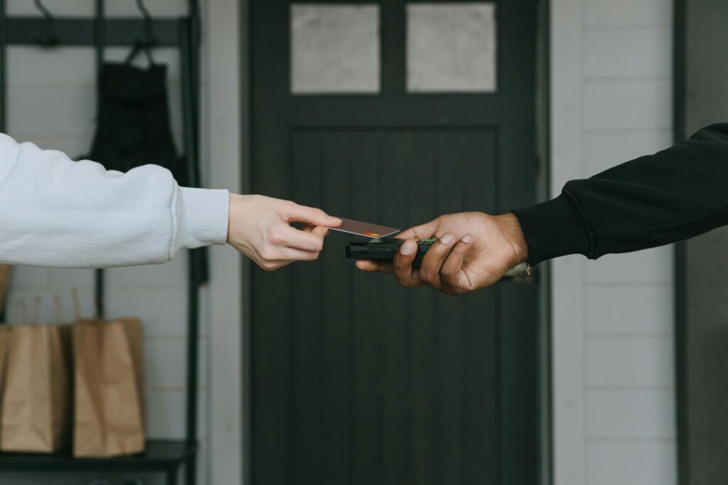 Close up of a person tapping their card to pay, symbolizing payment options for addiction treatment in Fresno, CA.