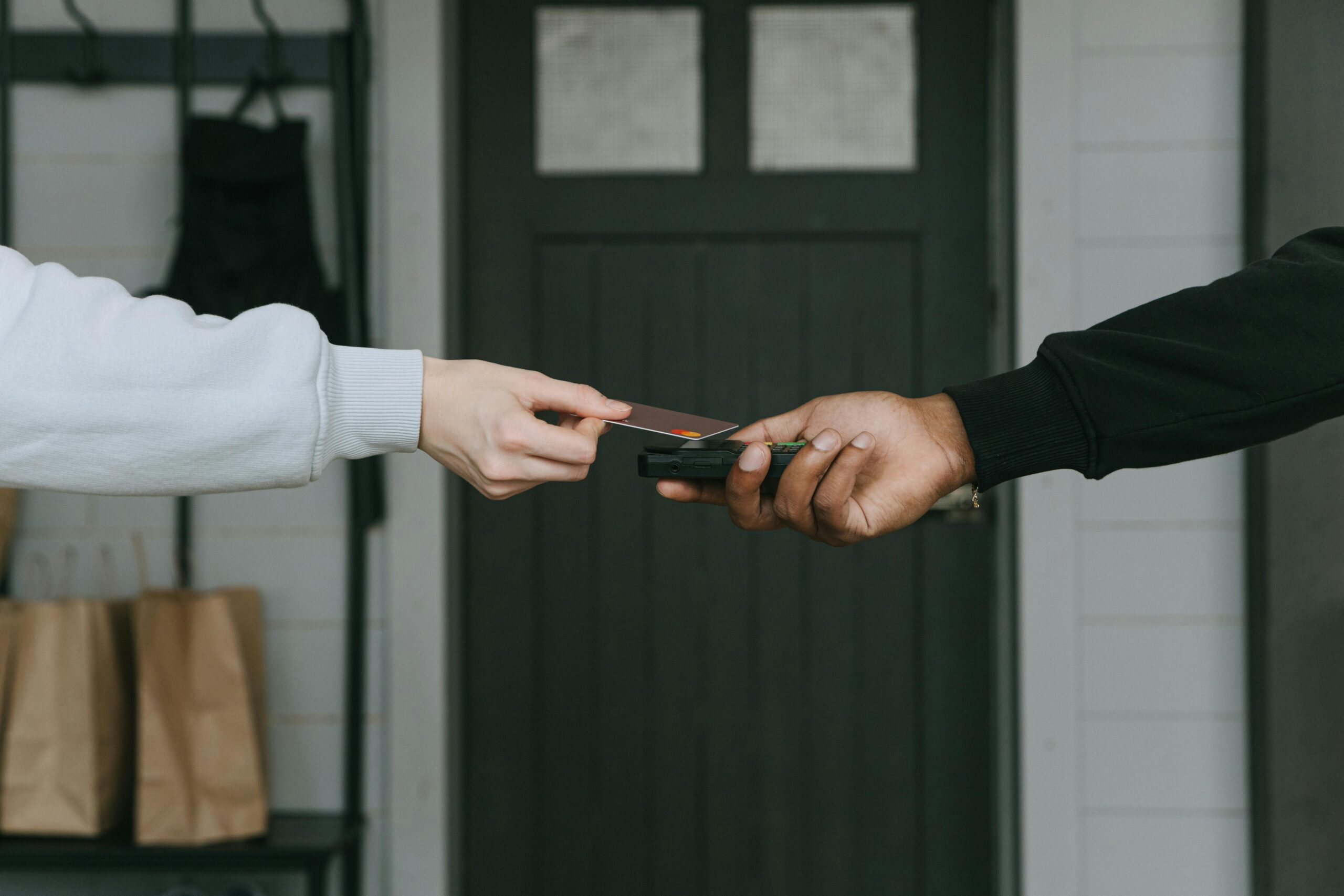 Close up of a person tapping their card to pay, symbolizing payment options for addiction treatment in Fresno, CA.