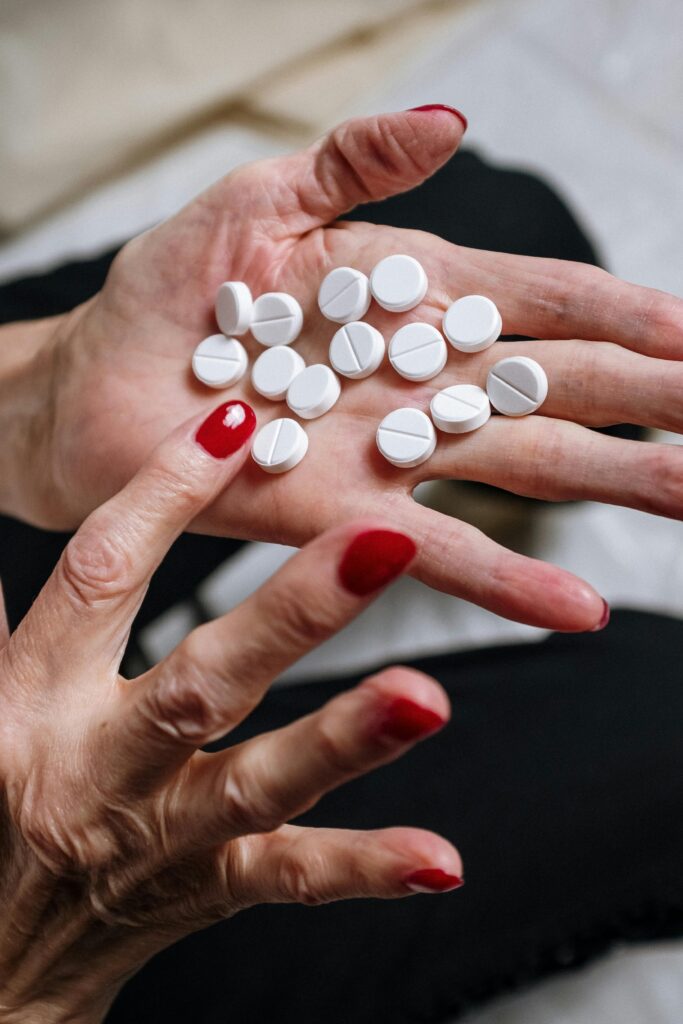 close up of a woman holding trazadone pills in her palm
