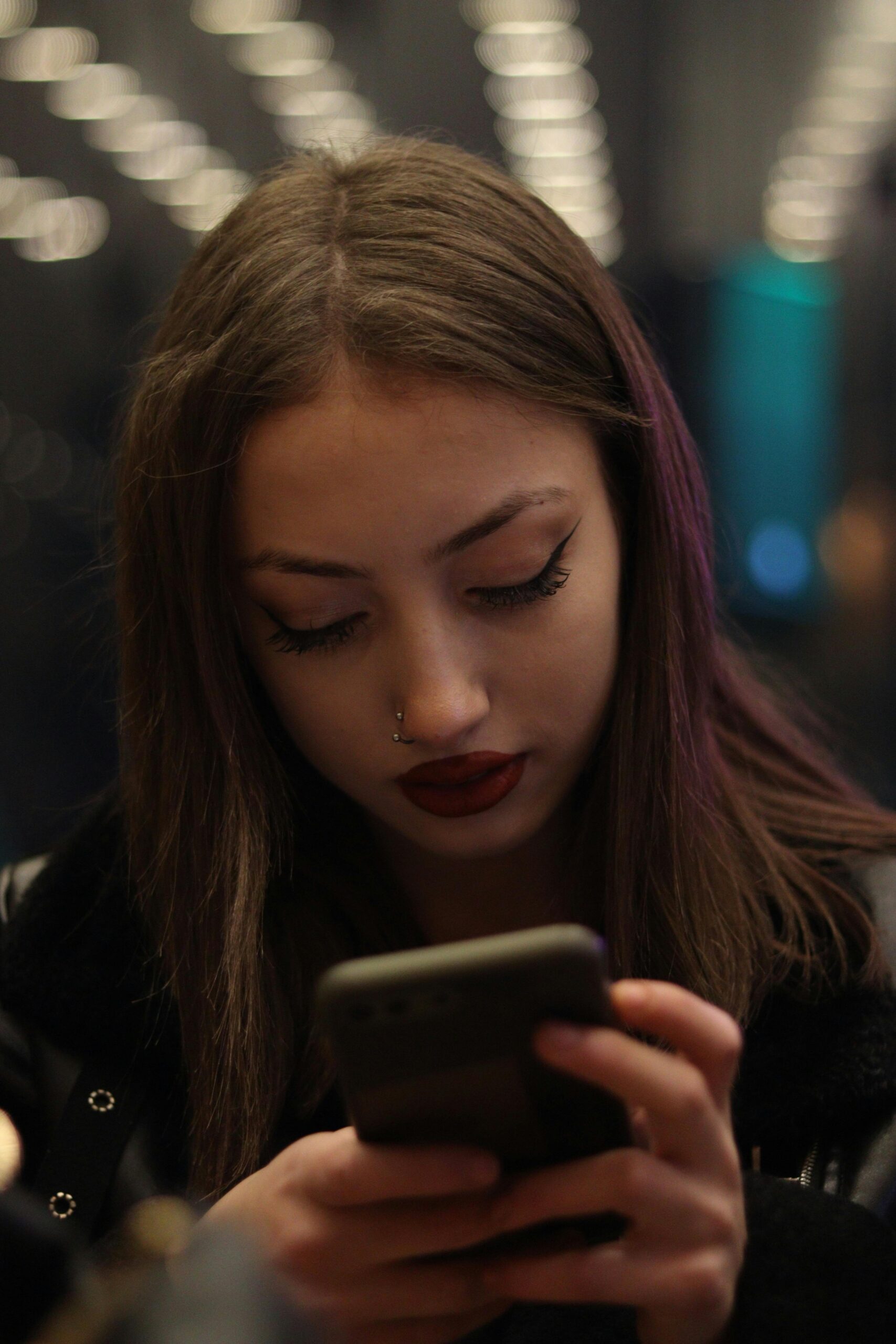 Woman starting at her phone symbolizing brain rot and the toll it takes on mental health.
