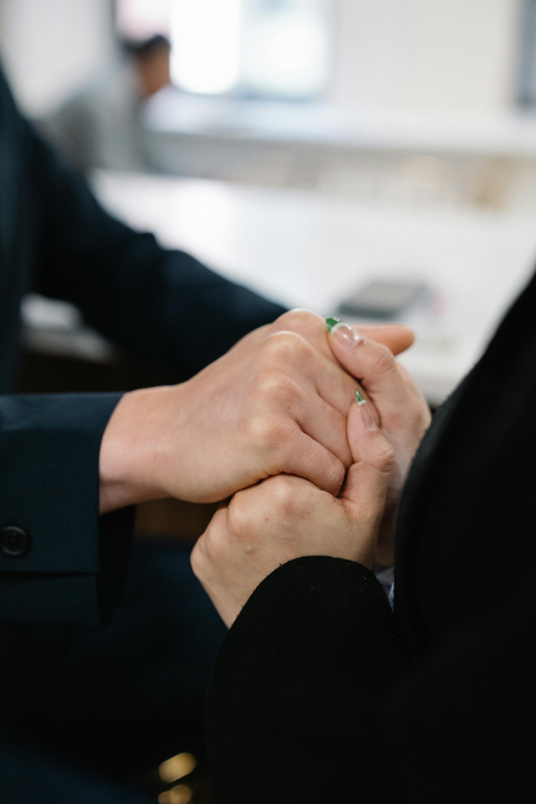 Close up of two women holding hands supporting each other as they progress through Fresno Drug Rehab.