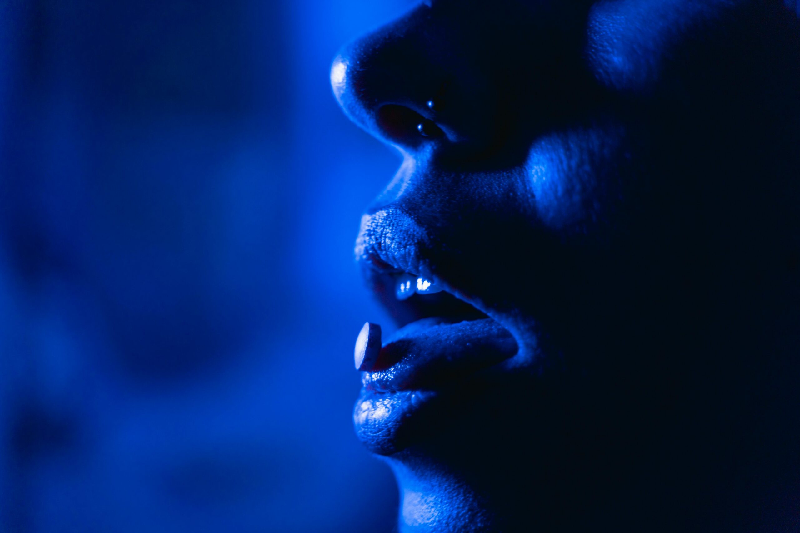 Close-up image of a person taking a pill, representing substance abuse and Fresno addiction treatment programs for long-term recovery and support.